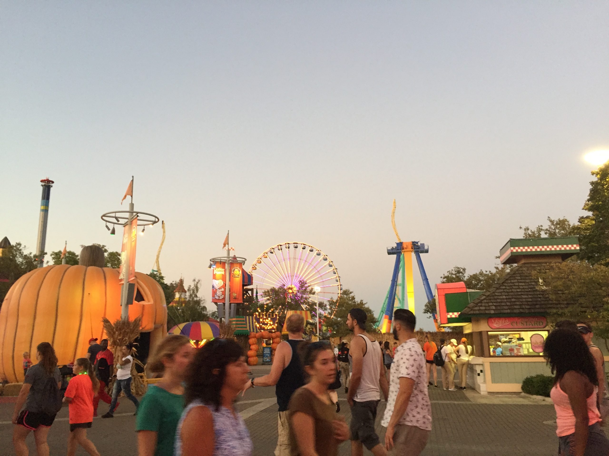 cedar point midway with pumpkin, people, and rides